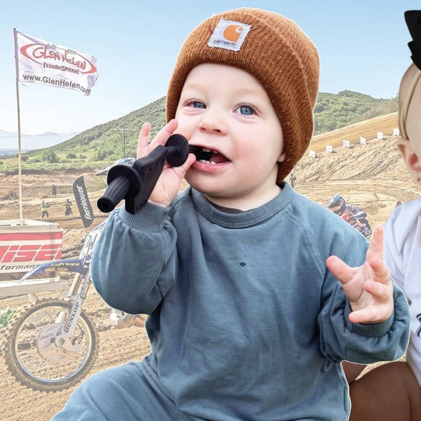 Baby at the track chewing a Moto Since Birth teether