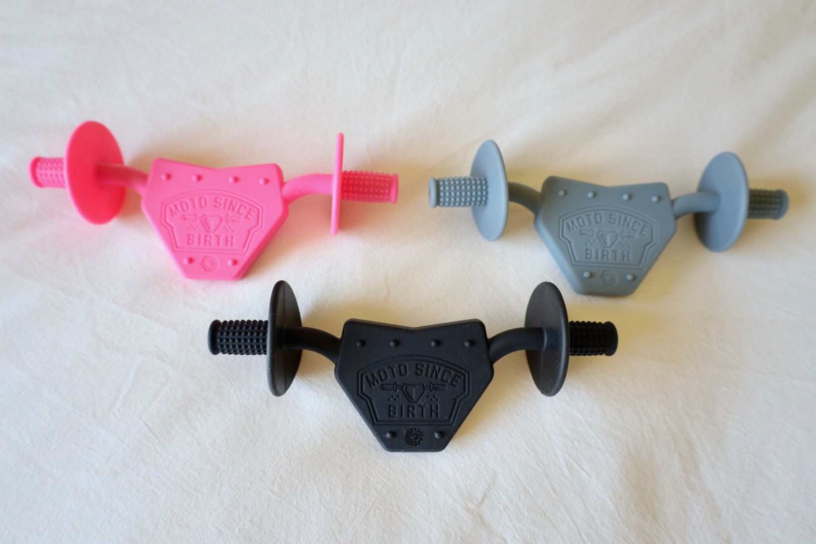 All three moto teether colors together: pink, gray and black