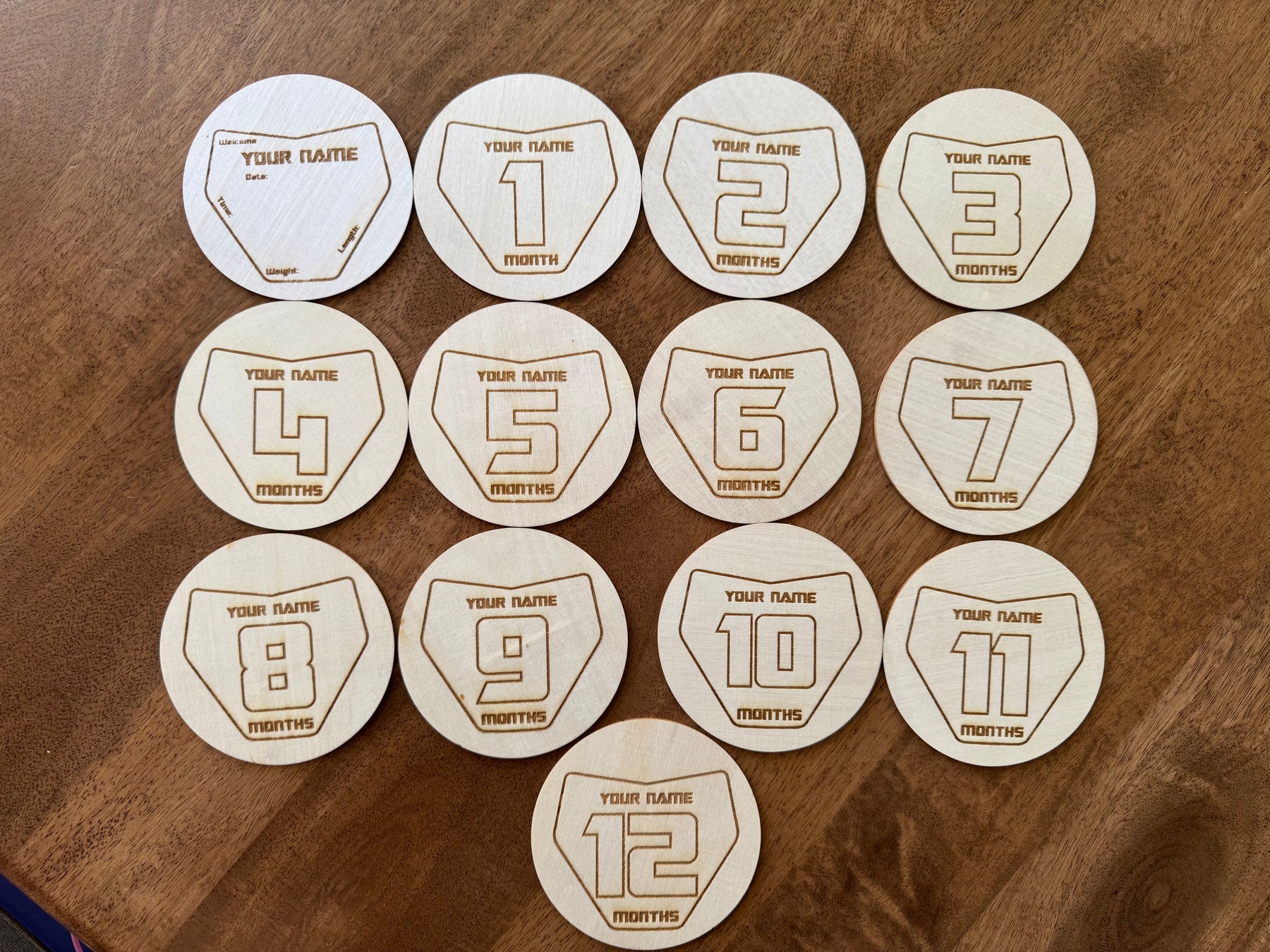 Engraved wooden Moto Milestones number plate discs, months 1 to 12