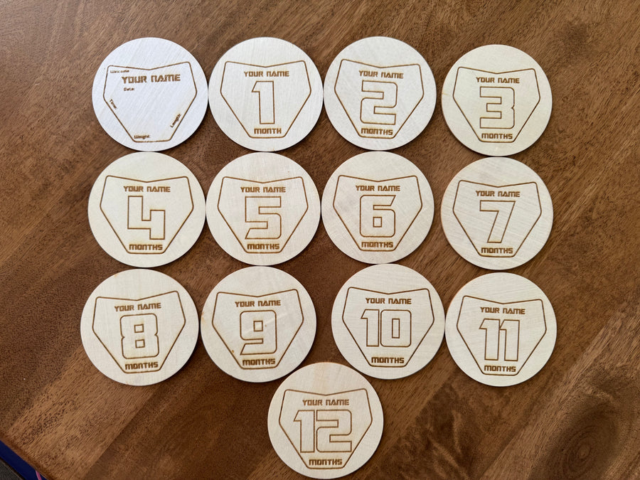 Engraved wooden Moto Milestones number plate discs, months 1 to 12