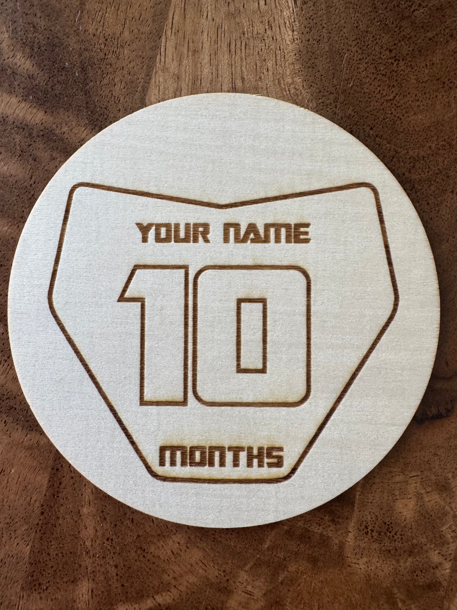 Engraved wooden Moto Milestones number plate discs, months 1 to 12